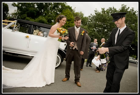 Gardenia wedding car chauffeur opening a bottle of champagne